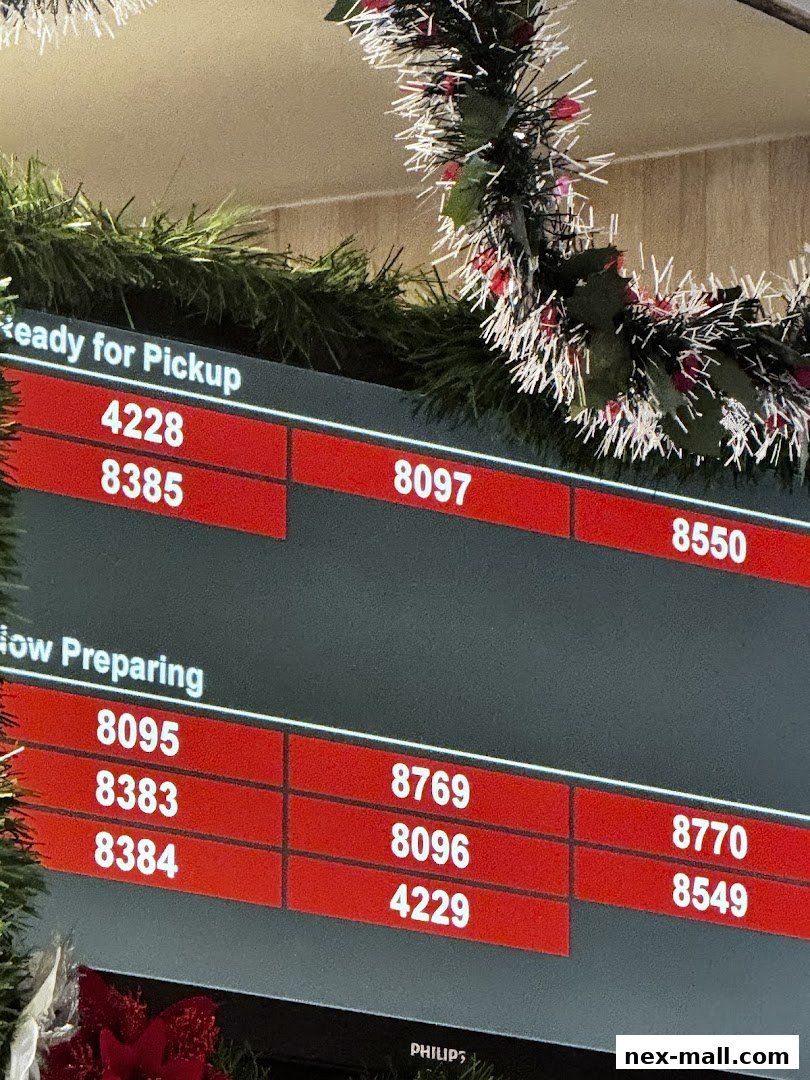A digital display shows order numbers for pickup and preparation, decorated with festive garlands.