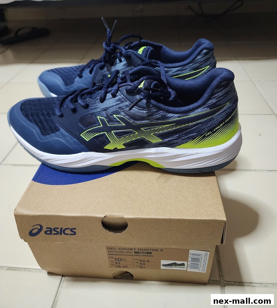 A pair of navy blue ASICS GEL-COURT HUNTER 3 shoes with neon green accents on a shoebox.