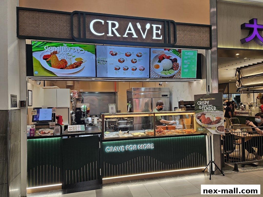The Crave Nasi Lemak shop front with illuminated signage and food displays.