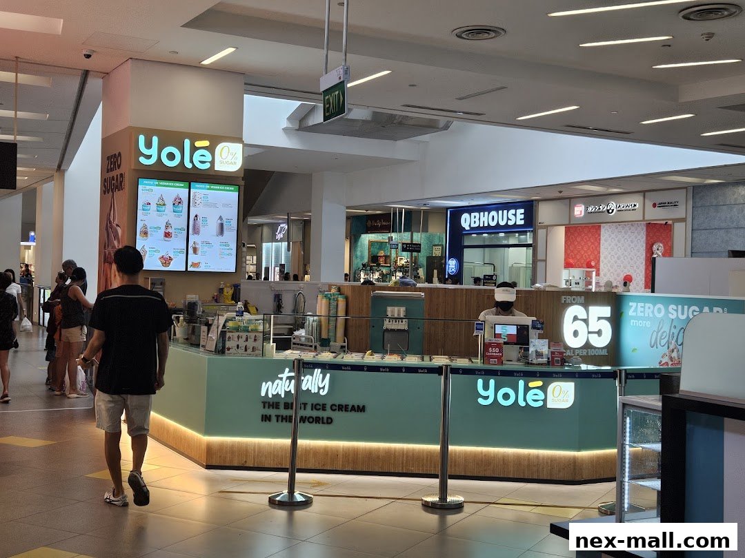 A Yolé Nex shop selling zero-sugar ice cream with a menu board and staff serving customers.