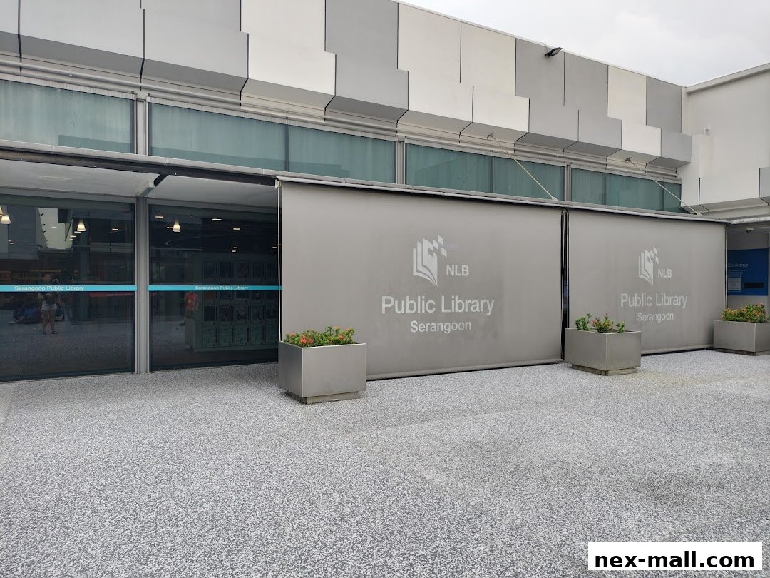 The entrance to Serangoon Public Library with large glass doors and signage.