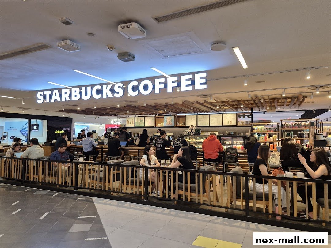 People enjoying coffee and conversation inside a busy Starbucks coffee shop.