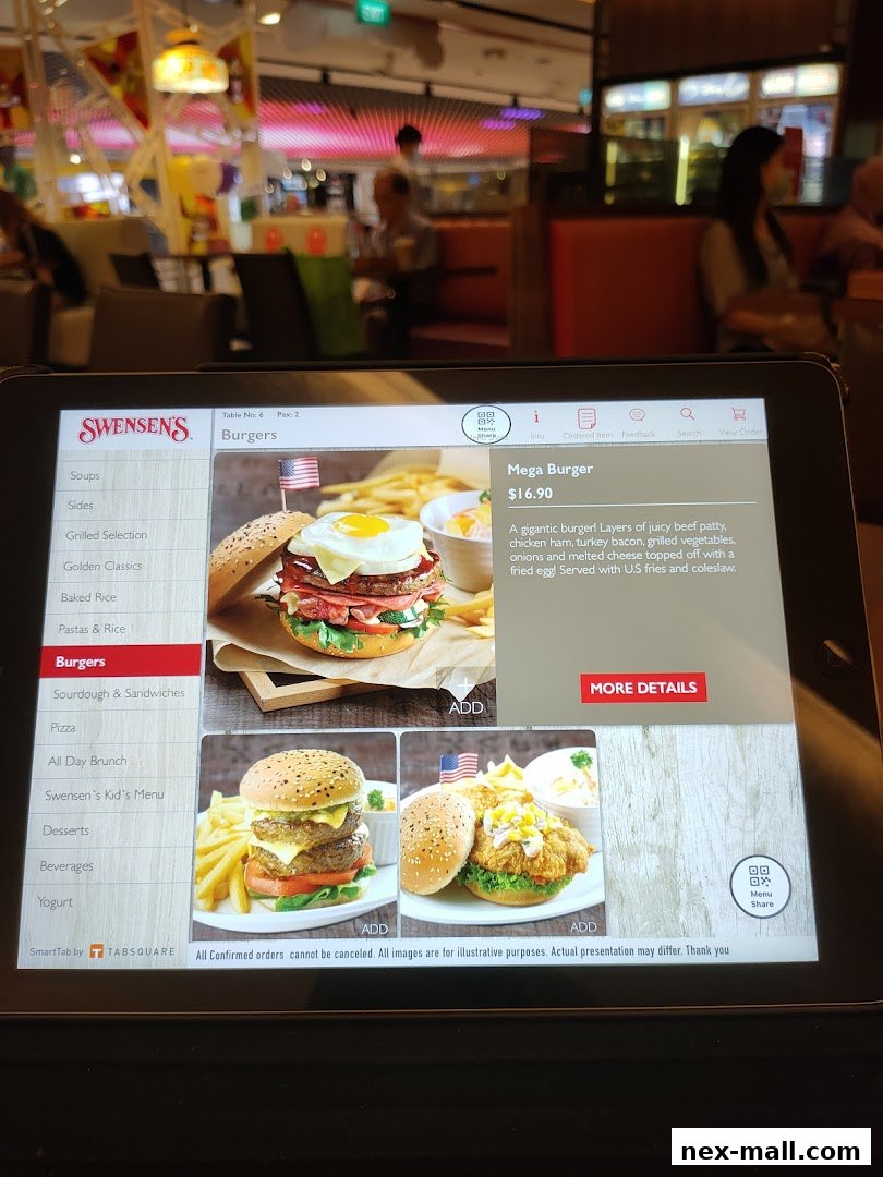 A tablet displays the Swensen's menu, featuring burgers and other food categories.