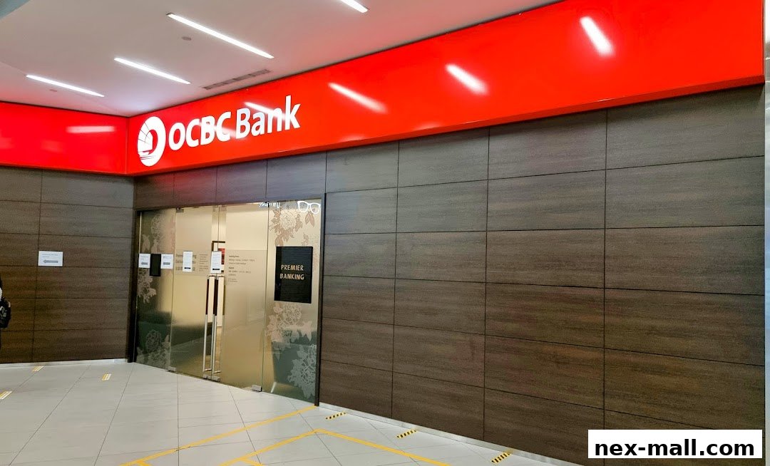 The entrance to OCBC Bank NEX, featuring a prominent red sign and modern wood-paneled walls.