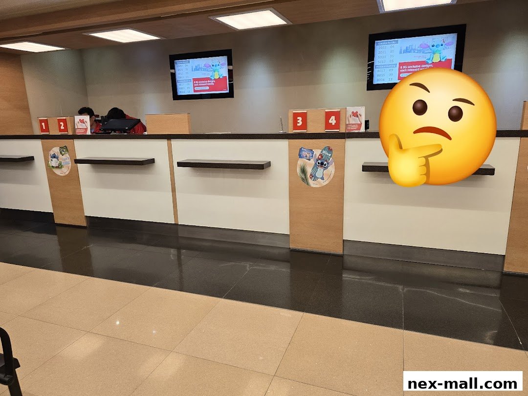 Interior view of a bank counter with digital displays and numbered service stations.
