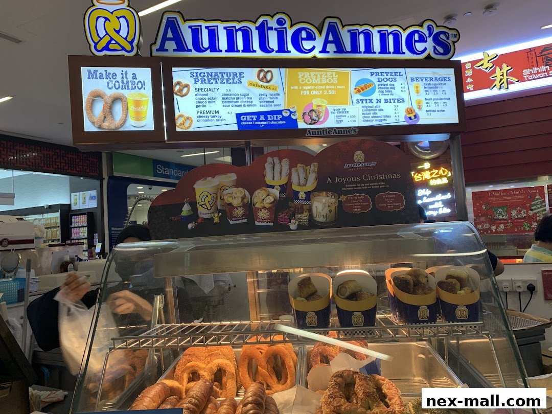 Auntie Anne's pretzel shop counter displaying a menu and freshly baked pretzels.
