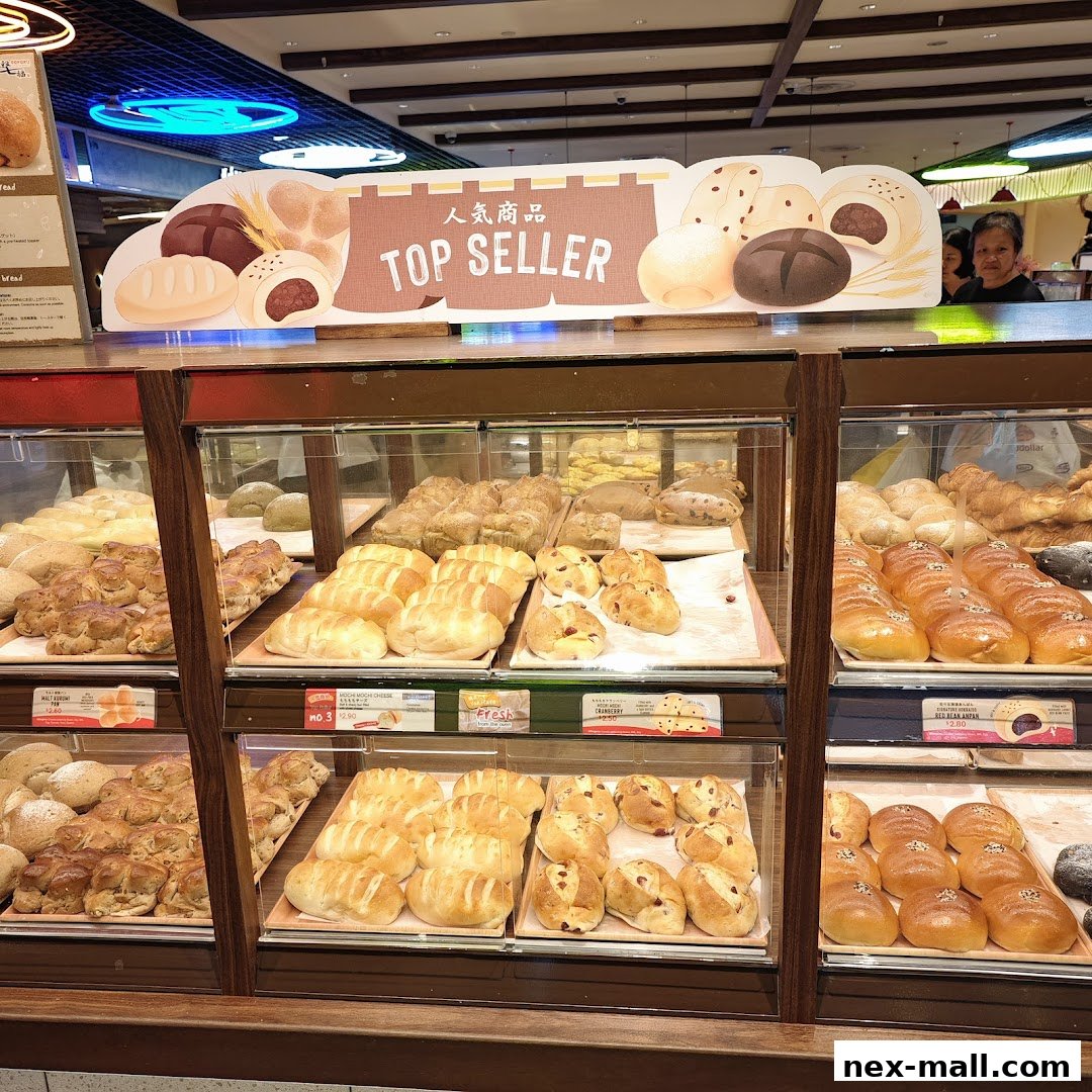 A display of freshly baked bread and pastries at a Japanese bakery.