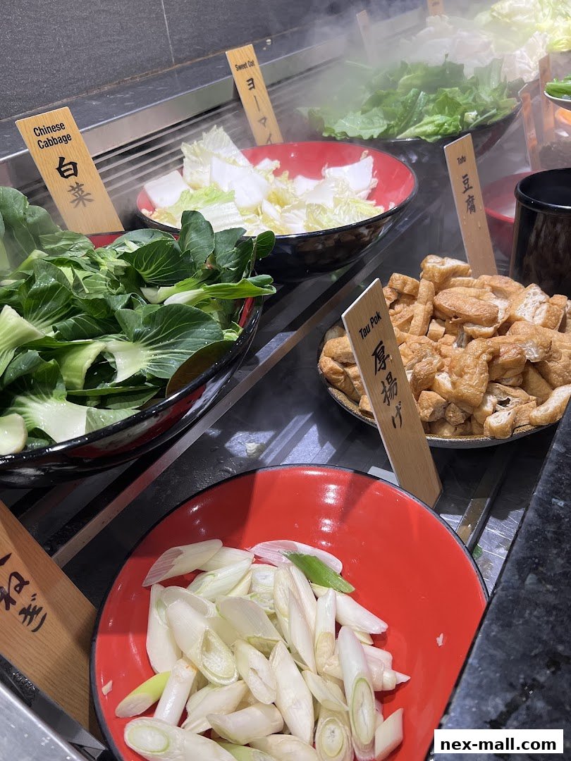 A variety of fresh ingredients for hot pot, including vegetables and tofu.