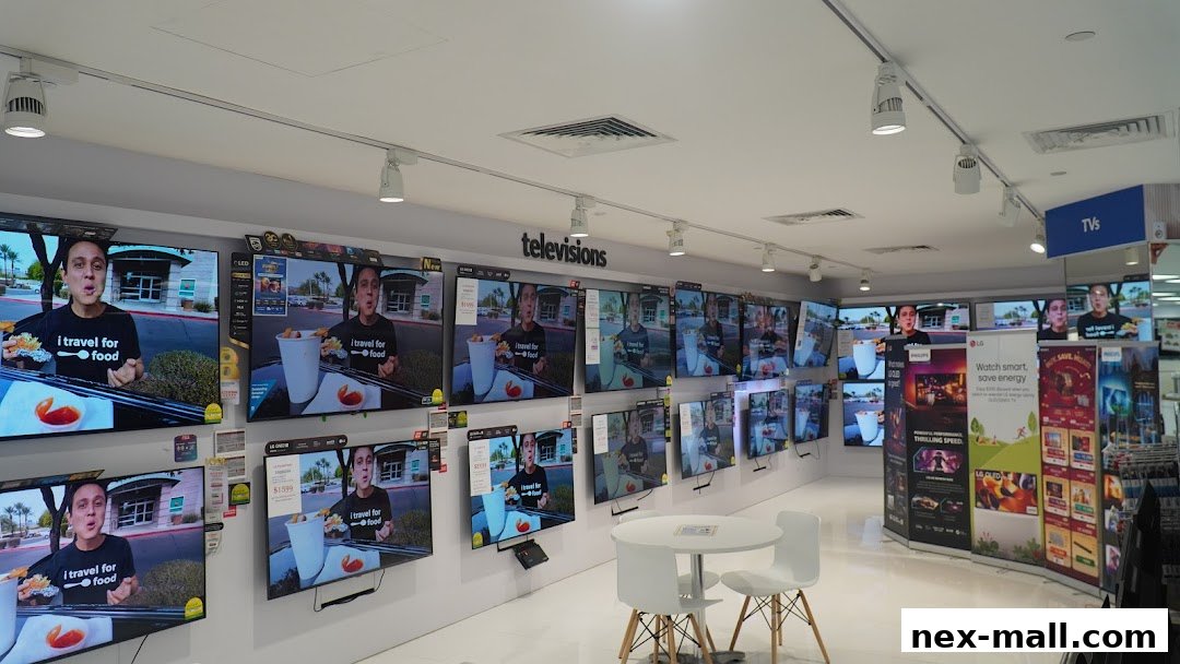A wide display of televisions showcasing a food vlogger, with promotional banners in the background.