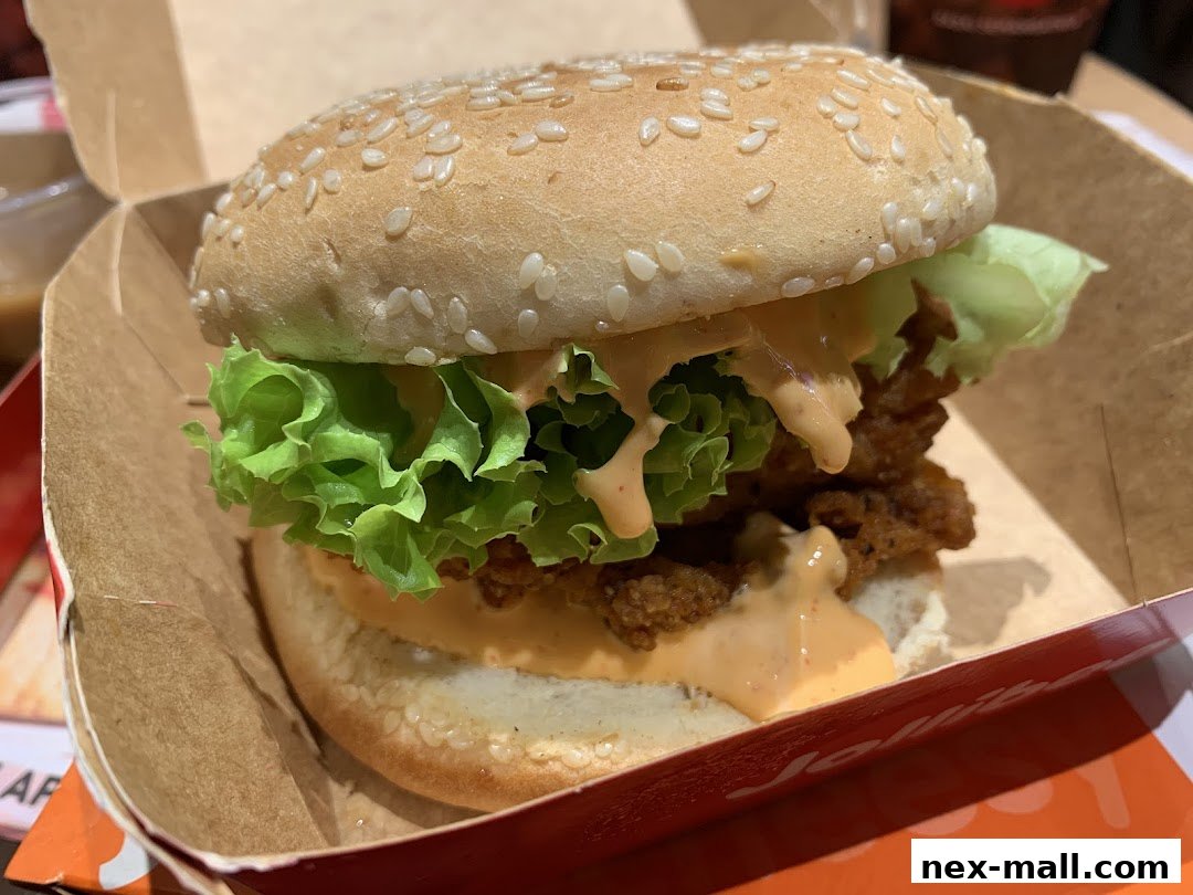 A close-up shot of a delicious Jollibee burger with lettuce and sauce.
