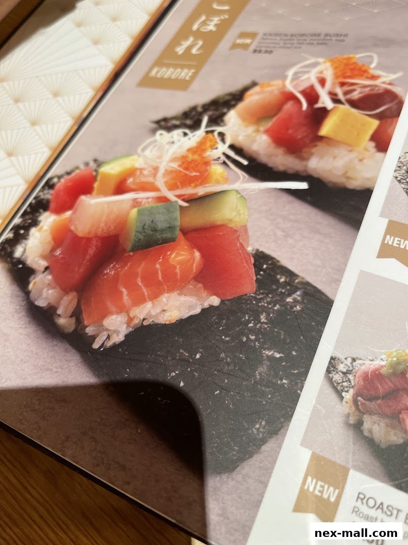 A close-up of a Japanese menu featuring colorful sushi dishes and text.