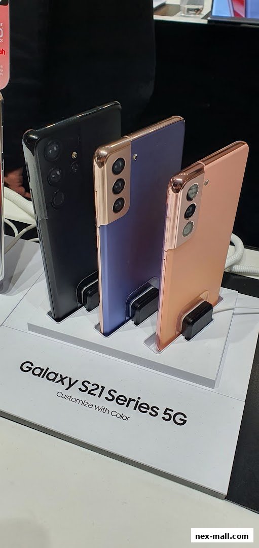 Three Samsung Galaxy S21 Series 5G phones in black, purple, and rose gold.