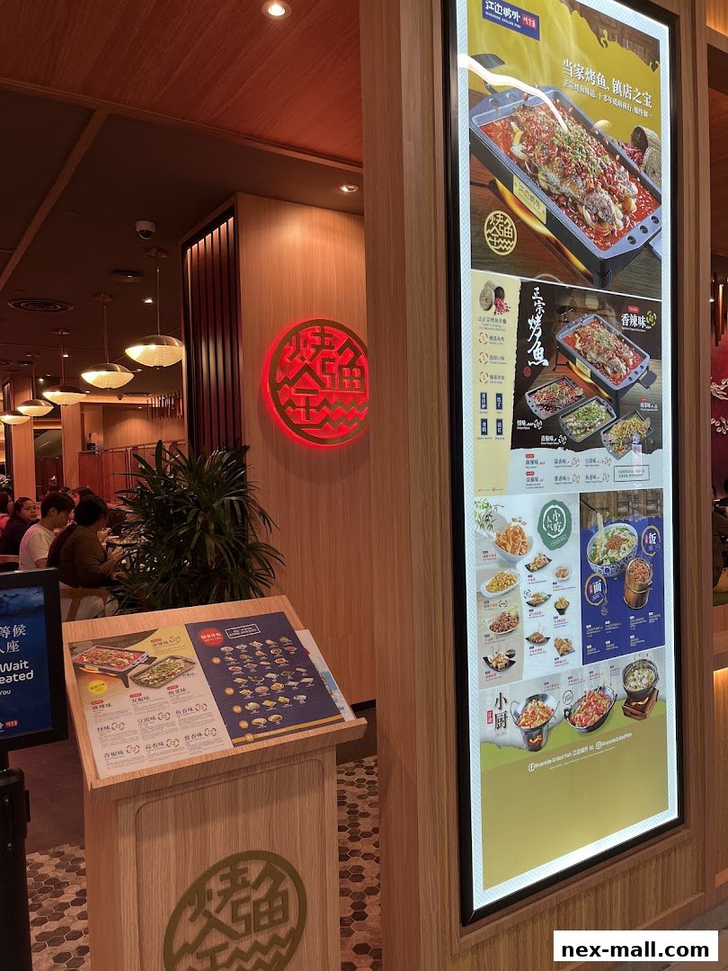 A restaurant entrance with a glowing sign and a digital menu displaying various dishes.