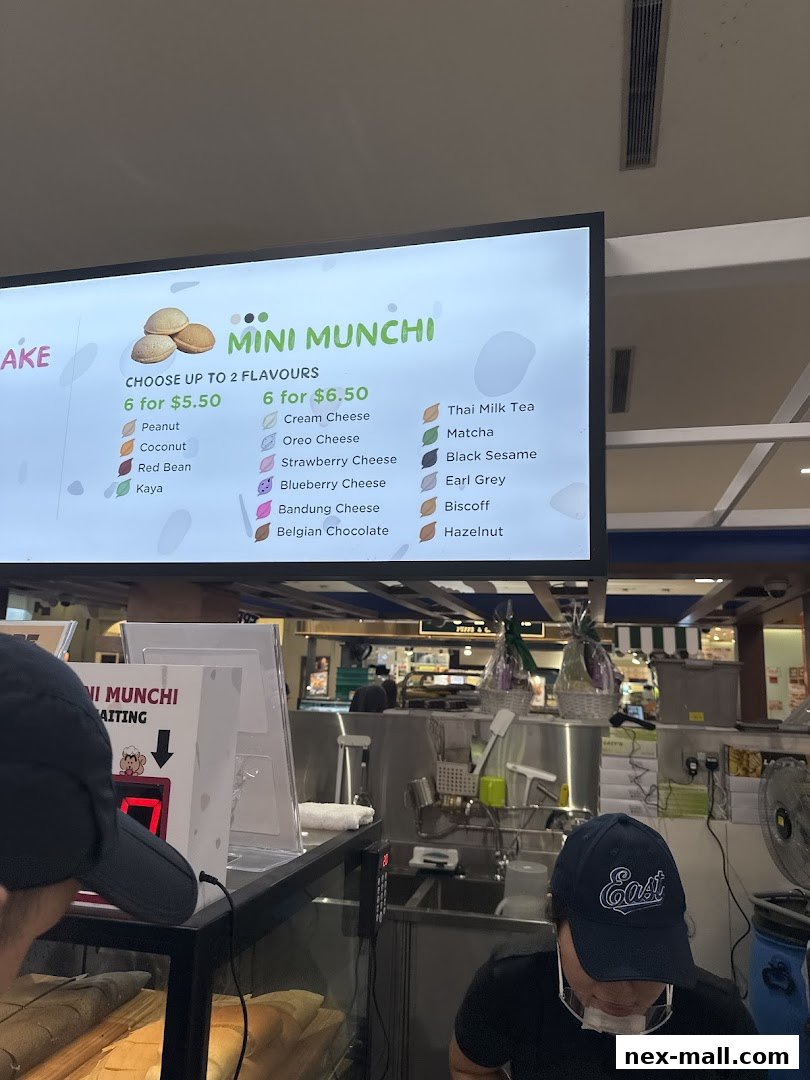 A digital menu board displays various flavors of Mini Munchi pancakes with pricing.