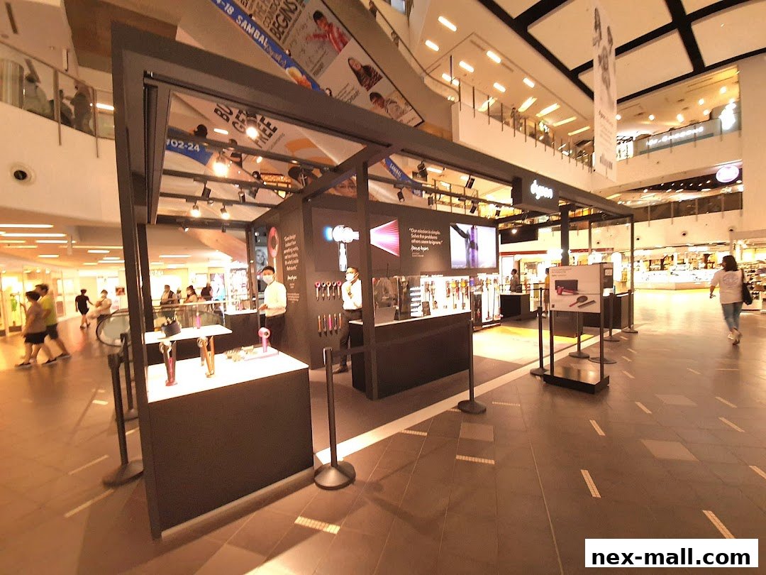 A Dyson store display featuring hair dryers and other personal care products in a mall.
