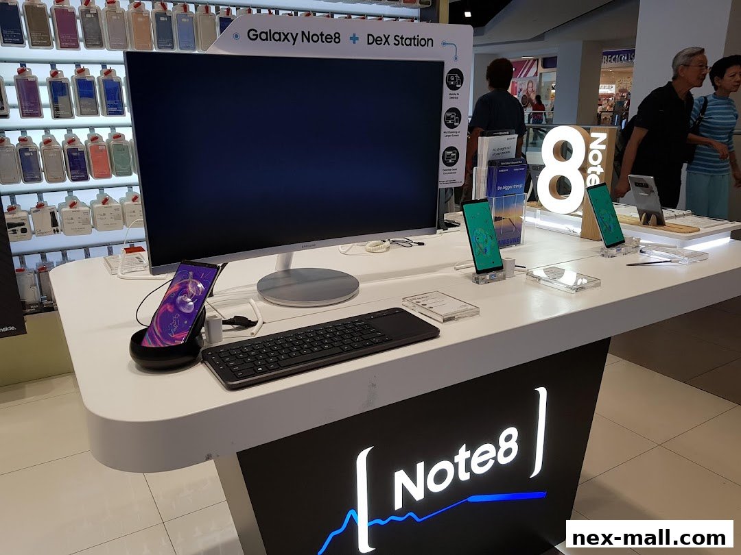 Samsung Galaxy Note 8 DeX Station display with phones, keyboard, and monitor.