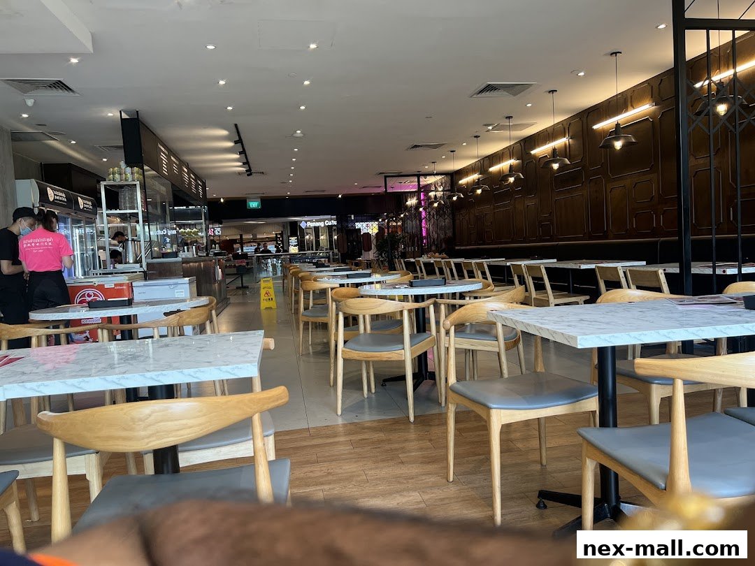 Interior view of a restaurant with tables, chairs, and a counter area.