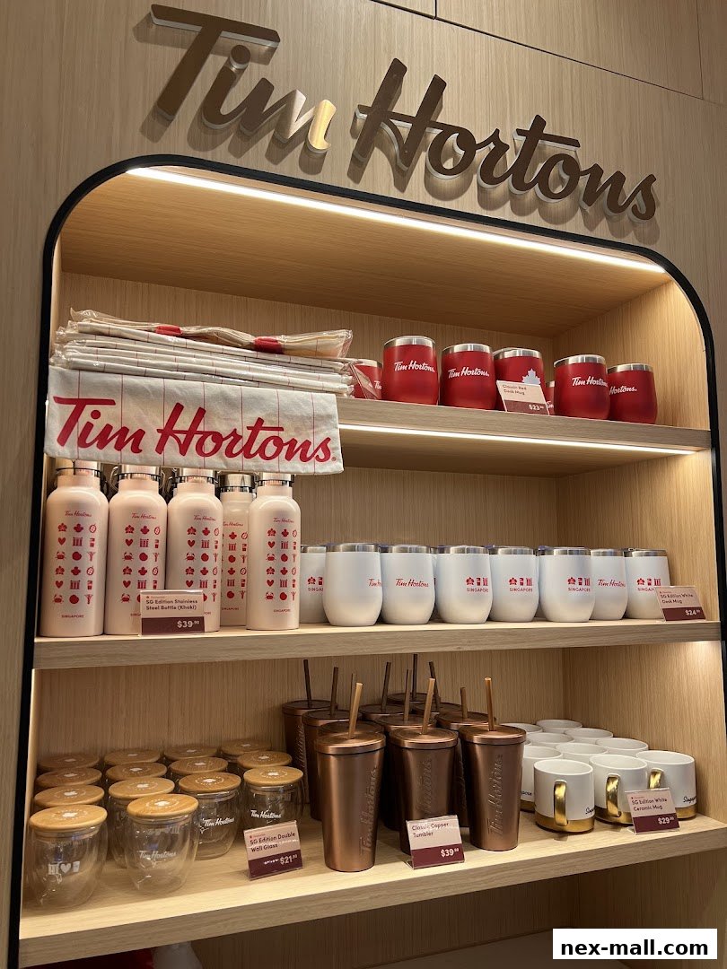 Shelves display various Tim Hortons branded merchandise, including tumblers, mugs, and water bottles.
