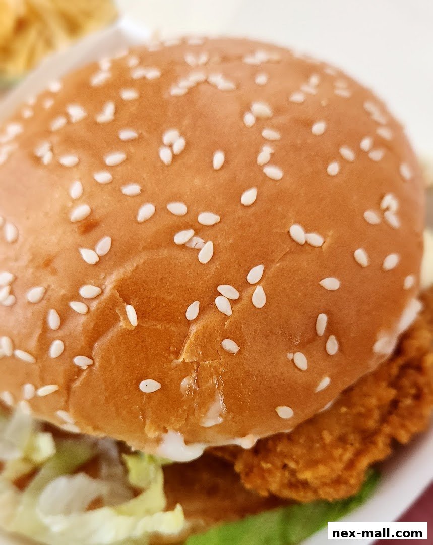 A close-up shot of a delicious McDonald's burger with sesame seeds on the bun.