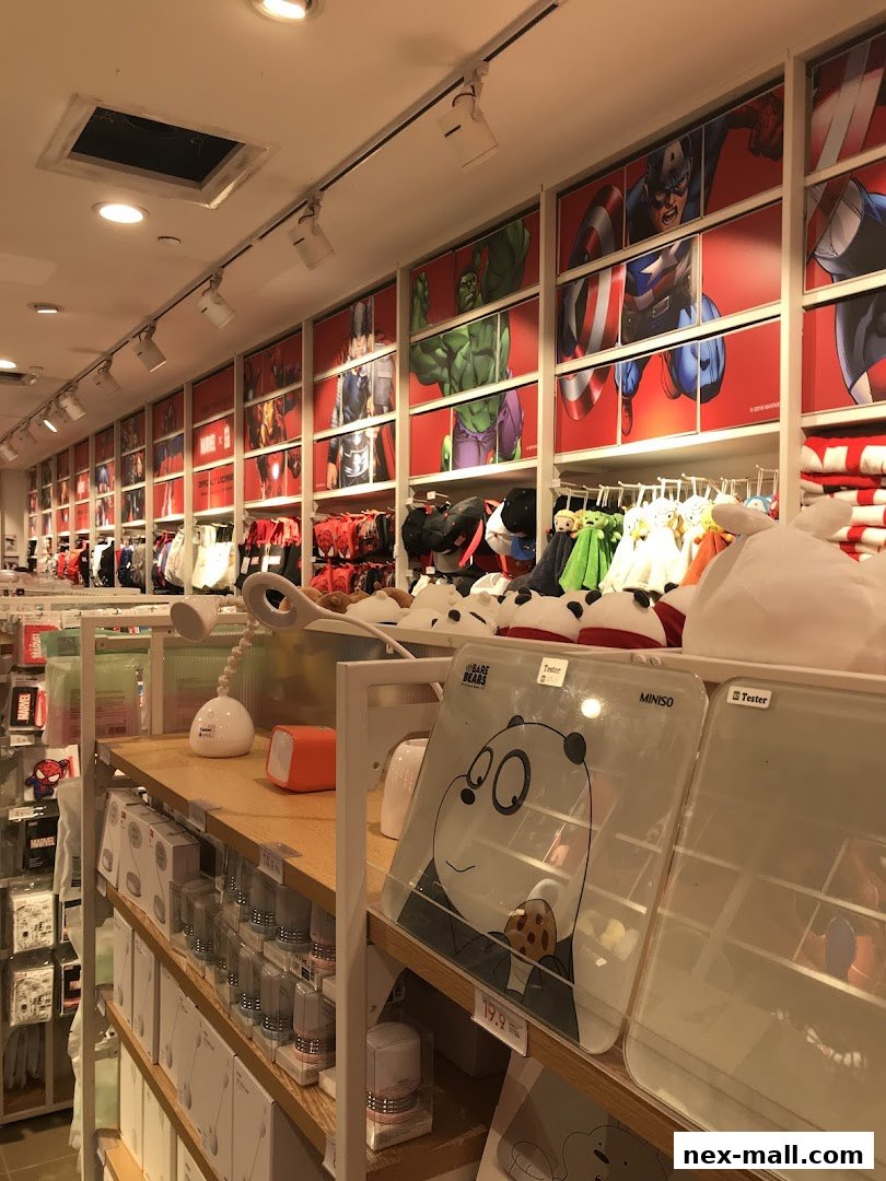 Interior of a MINISO store featuring Marvel character displays and various merchandise on shelves.