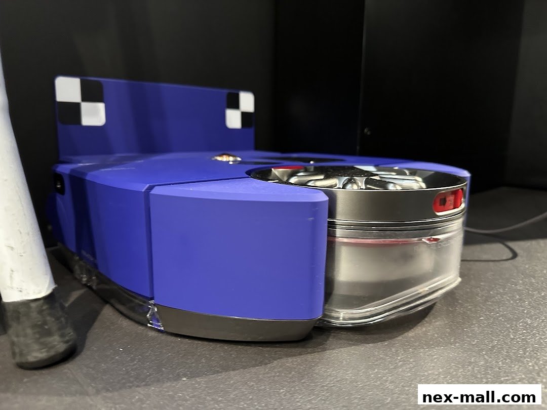 A close-up view of a blue Dyson robot vacuum cleaner with a transparent dustbin.