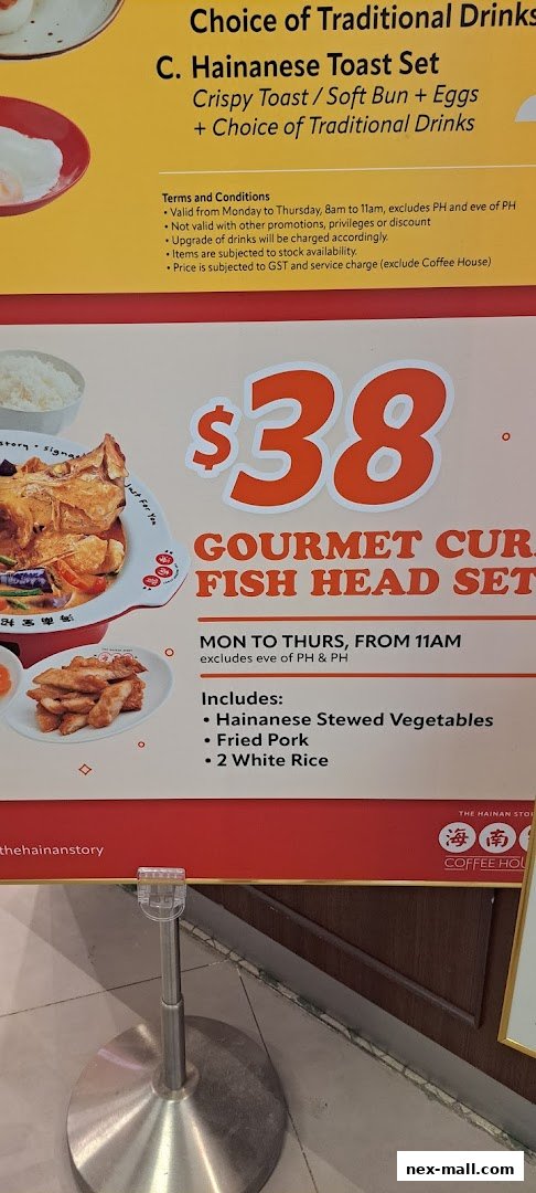 A menu board showcasing Hainanese toast sets and a gourmet fish head set with prices and inclusions.