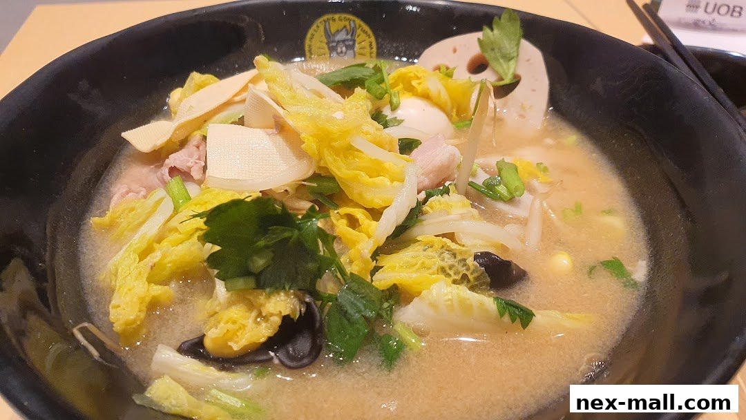 A close-up of a steaming bowl of Mala Tang with various ingredients like cabbage, tofu, and meat.