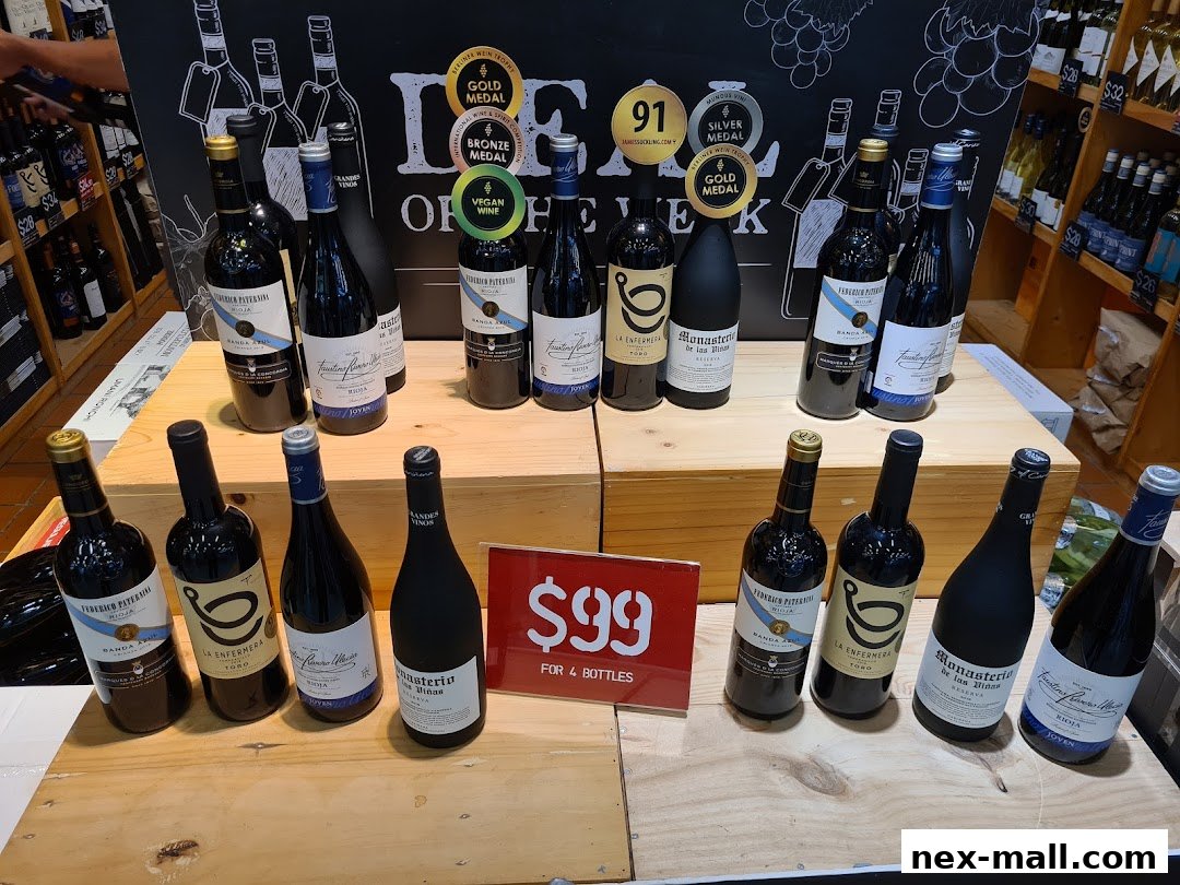 A display of various wine bottles, some with award stickers, and a special offer sign.