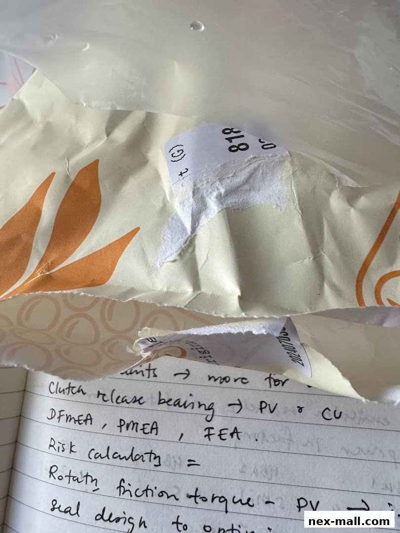 A notebook with handwritten technical notes and torn paper with labels.