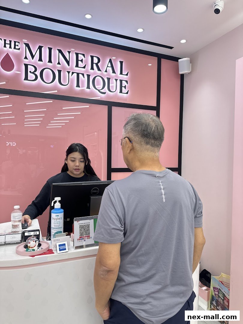 A customer interacts with a staff member at the counter of The Mineral Boutique.