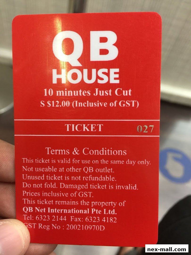 A red ticket for QB House offering a 10-minute haircut for S$12.00.