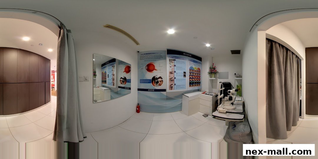 Interior of an optical shop with eye examination equipment and informational posters.