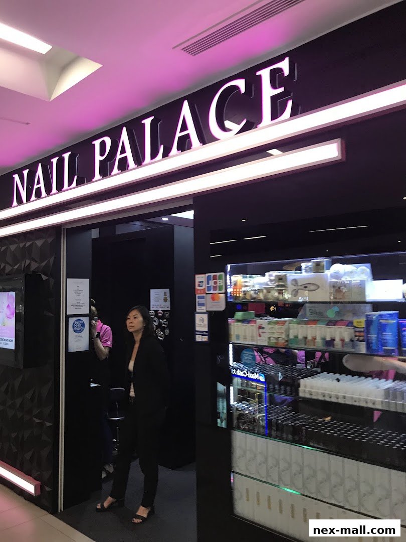 The entrance to Nail Palace, a modern nail salon with illuminated signage and product displays.