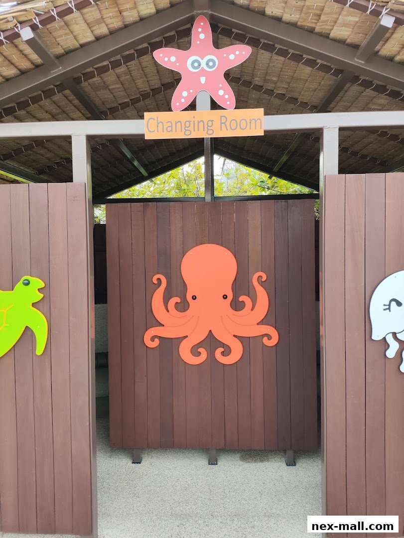 A changing room entrance decorated with colorful sea creatures and a starfish.