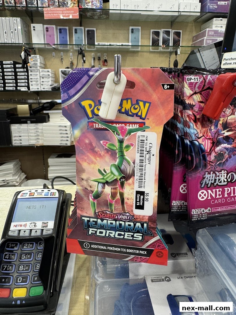 Pokemon trading card booster packs and a payment terminal are displayed in a retail store.