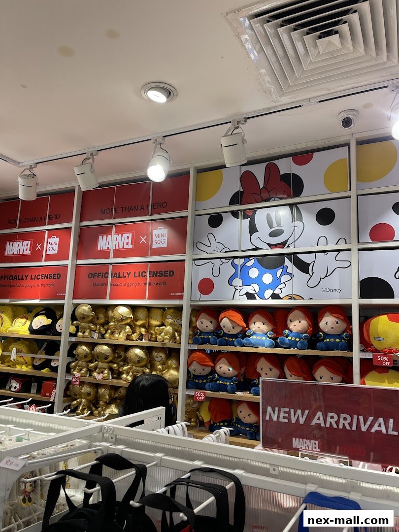 Interior of a MINISO NEX store featuring Marvel and Disney merchandise, including plush toys and bags.