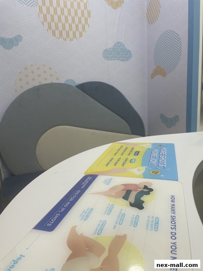 A table with promotional flyers for IPL hair removal shots and a comfortable seating area.