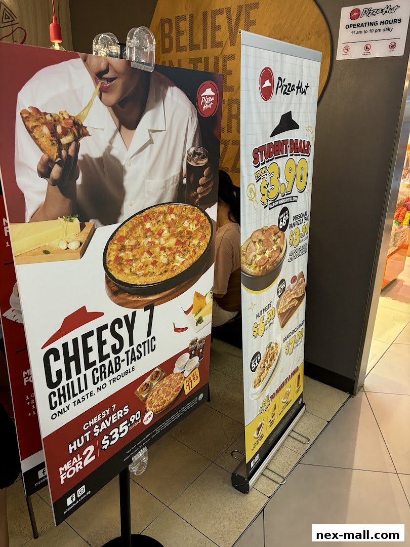 Promotional displays for Pizza Hut featuring student deals and a Cheesy 7 Chilli Crab-Tastic meal.