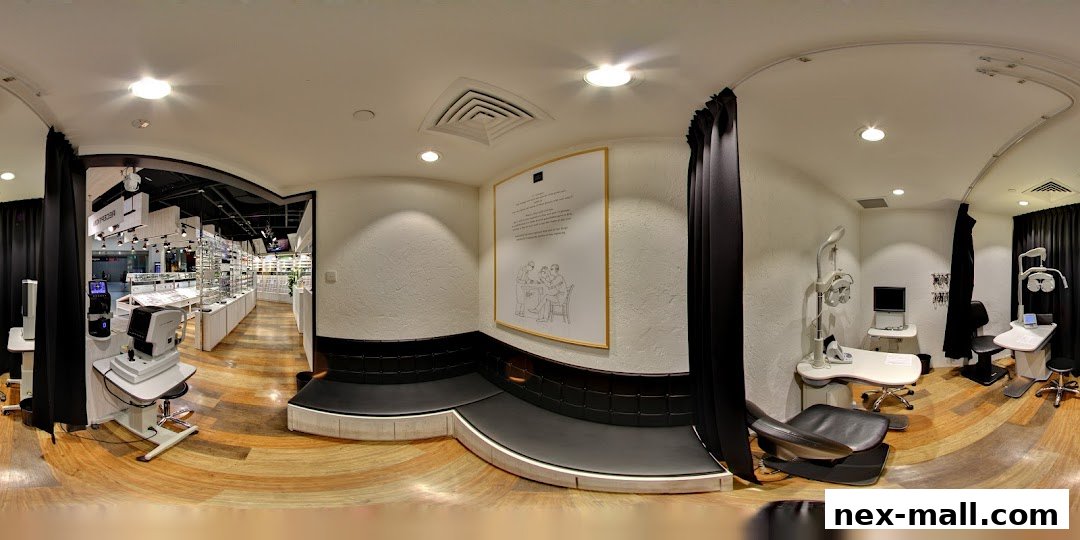 Interior view of an optical shop with eye examination equipment and eyewear displays.
