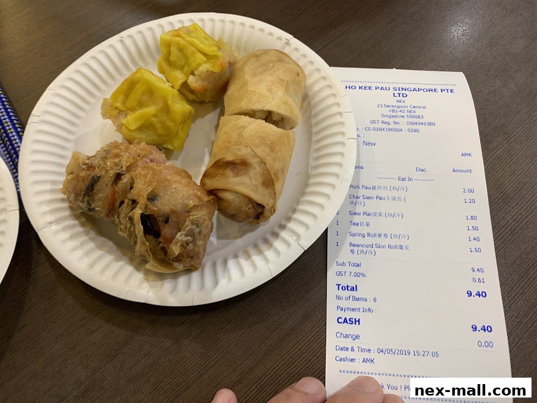 A plate of dim sum and spring rolls with a receipt from Ho Kee Pau.