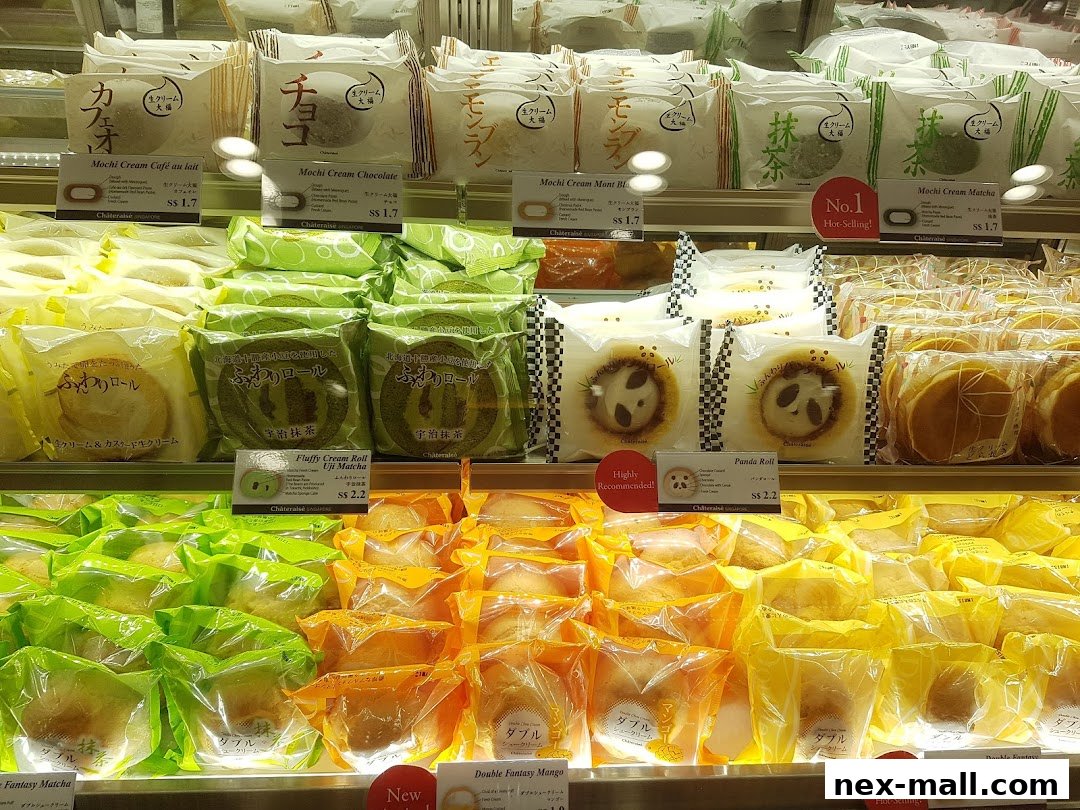 A display of various individually packaged Japanese pastries and cakes in a retail shop.
