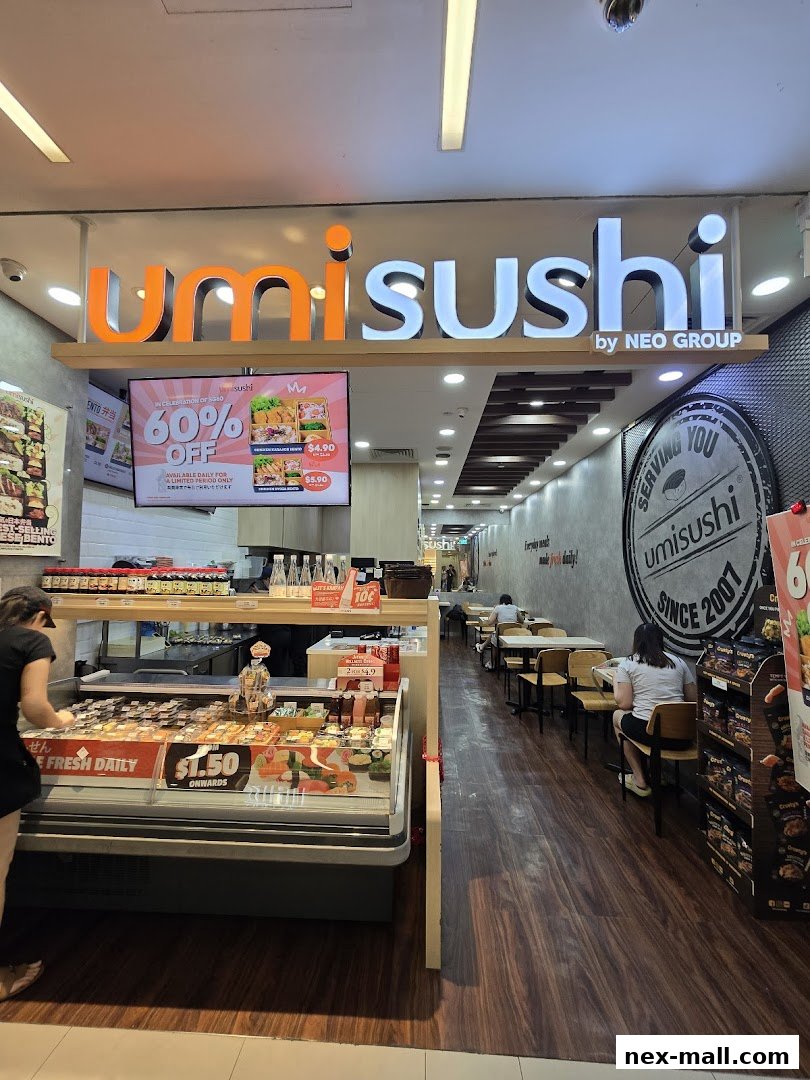 The interior of a sushi shop with a display of fresh sushi and seating area.