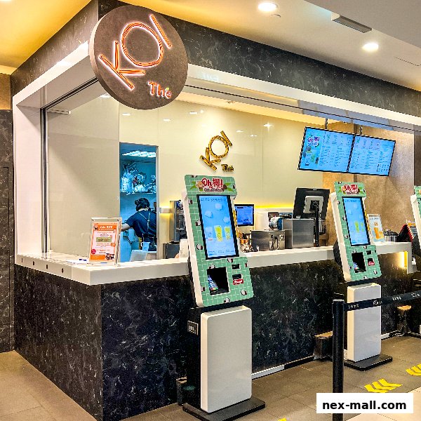 KOI Thé NEX shop with ordering kiosks and digital menu boards.