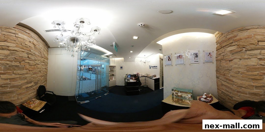 Interior of a hair loss treatment salon with a reception desk and stone-clad walls.