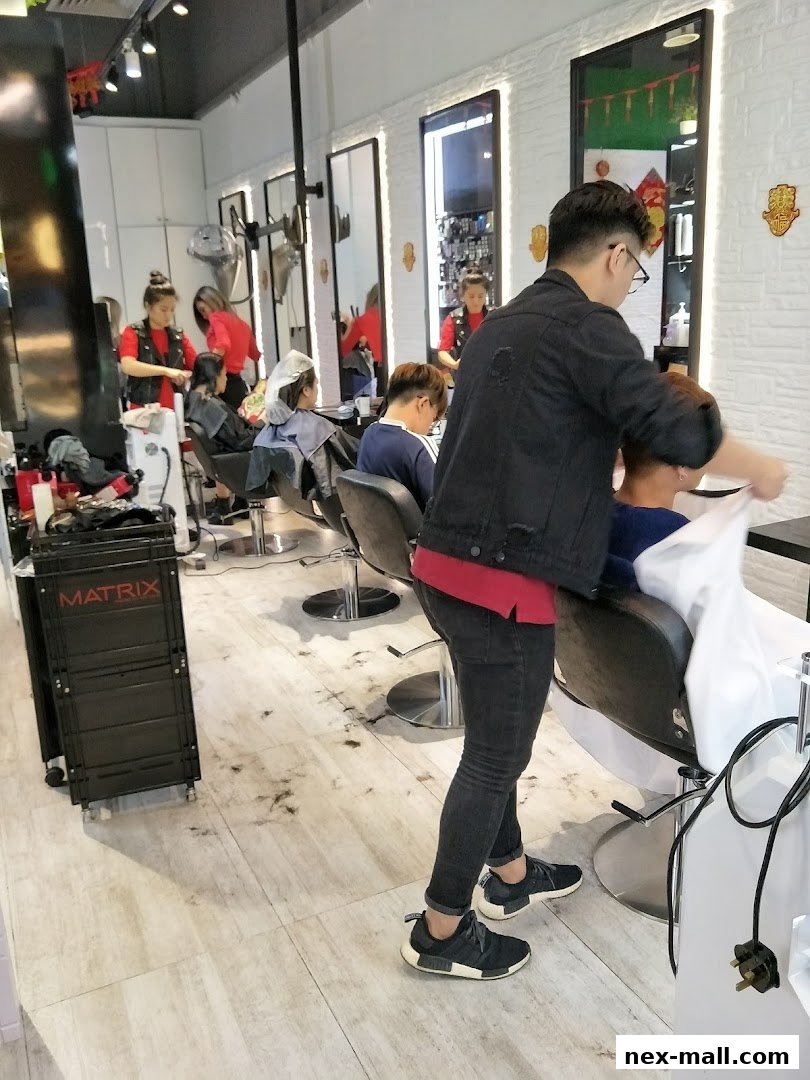 Hair stylists working on clients inside a modern hair studio with mirrors and styling chairs.