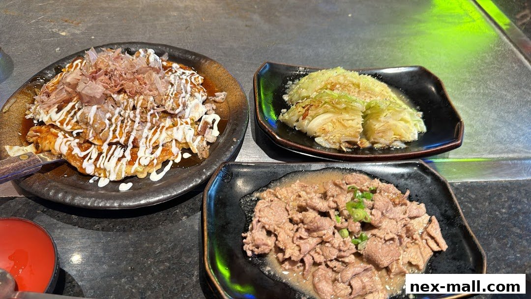 Three plates of Japanese food: okonomiyaki, grilled cabbage, and stir-fried beef.