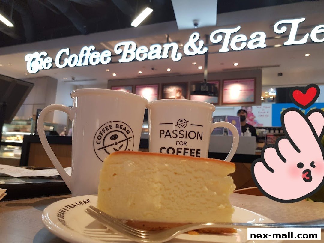A slice of cheesecake with two mugs at The Coffee Bean & Tea Leaf.