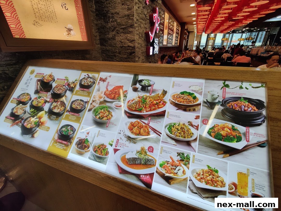 A brightly lit menu display showcasing various Chinese dishes and soups with appealing food photography.
