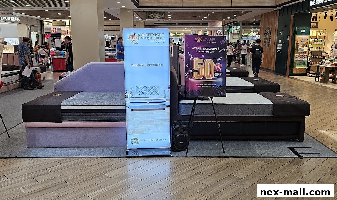 A retail display featuring mattresses and promotional signage for SLEEPNIGHT Lifestyle Mattress.