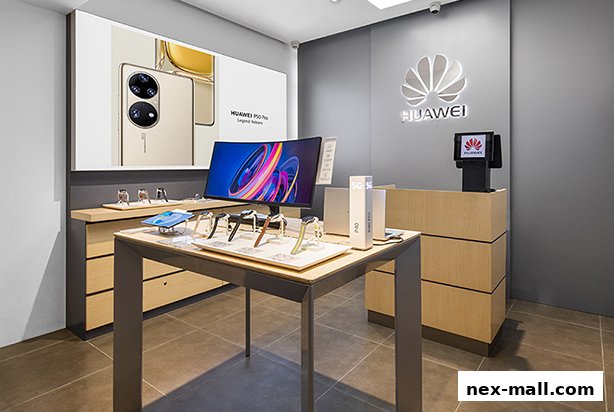 Interior of a Huawei concept store showcasing smartphones and smartwatches on display tables.